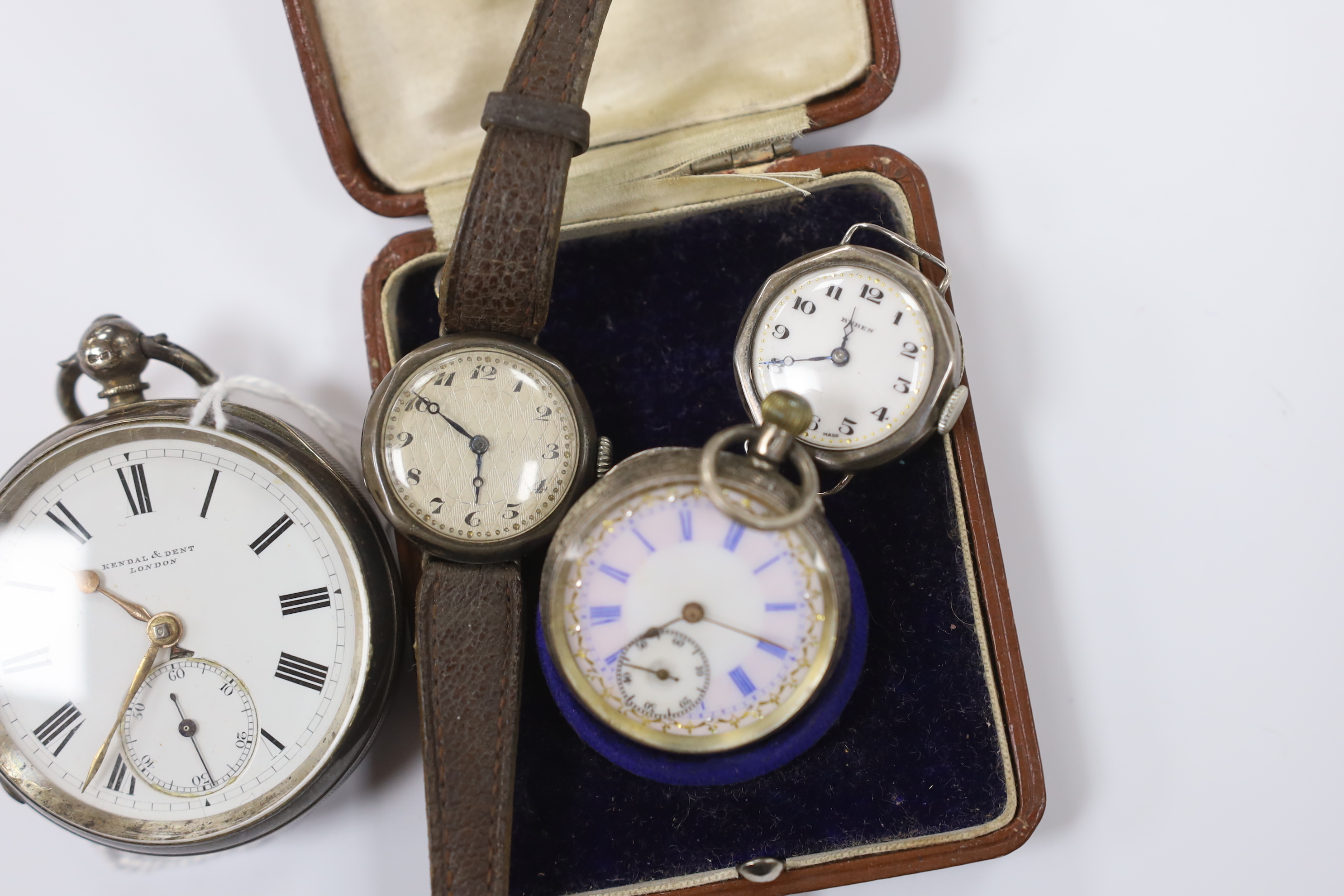 A late Victorian silver open face pocket watch, retailed by Kendall & Dent, a cased Swiss 935 standard white metal fob watch and two silver manual wind wrist watches.